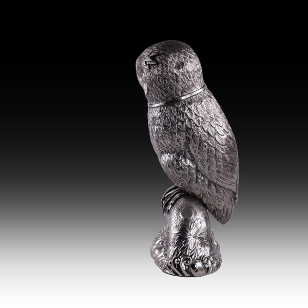 A silver drinking vessel in the shape of an owl